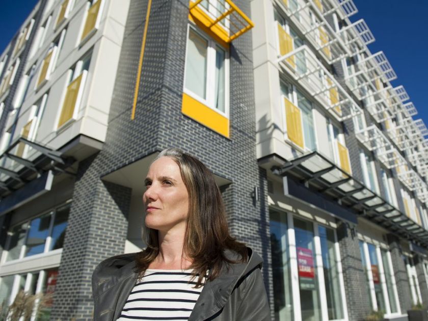 photo of a woman in front of a building